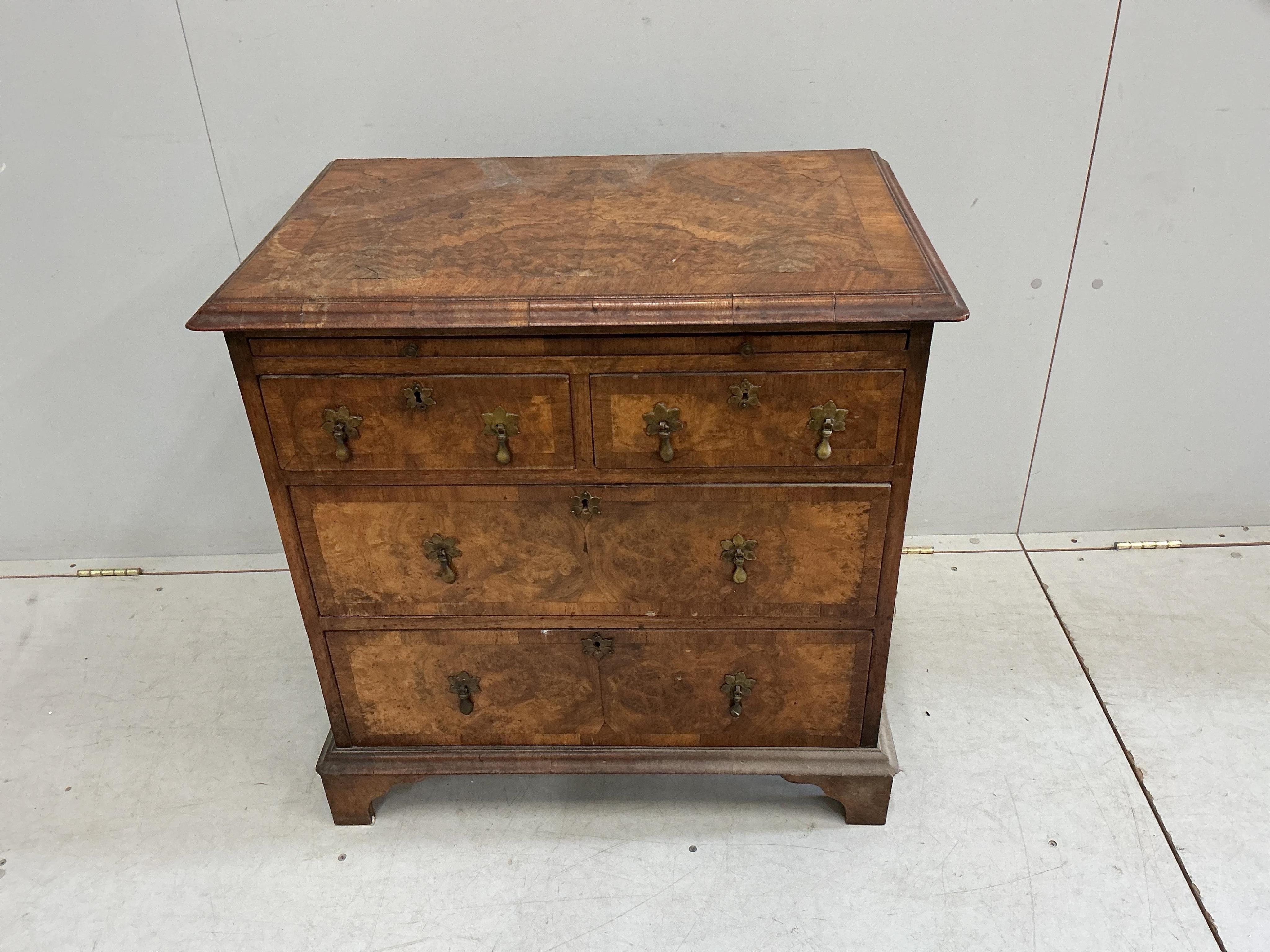 A small Queen Anne Revival crossbanded walnut bachelor’s chest with slide, width 71cm, depth 45cm, height 72cm